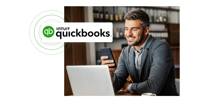 Man looking at his phone and smiling with screenshot of Quickbooks logo